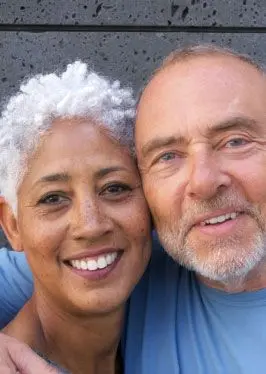 Charla and Alex in front of a wall, they met on Match dating app.